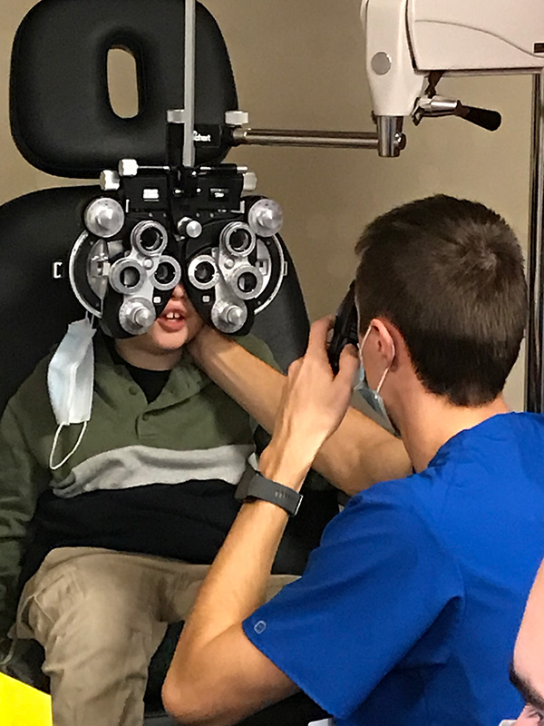 MCO student completing an eye exam