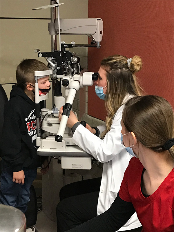 MCO student completing an eye exam