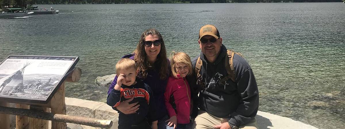 Dr. Lodholtz and his family posing before a mountain