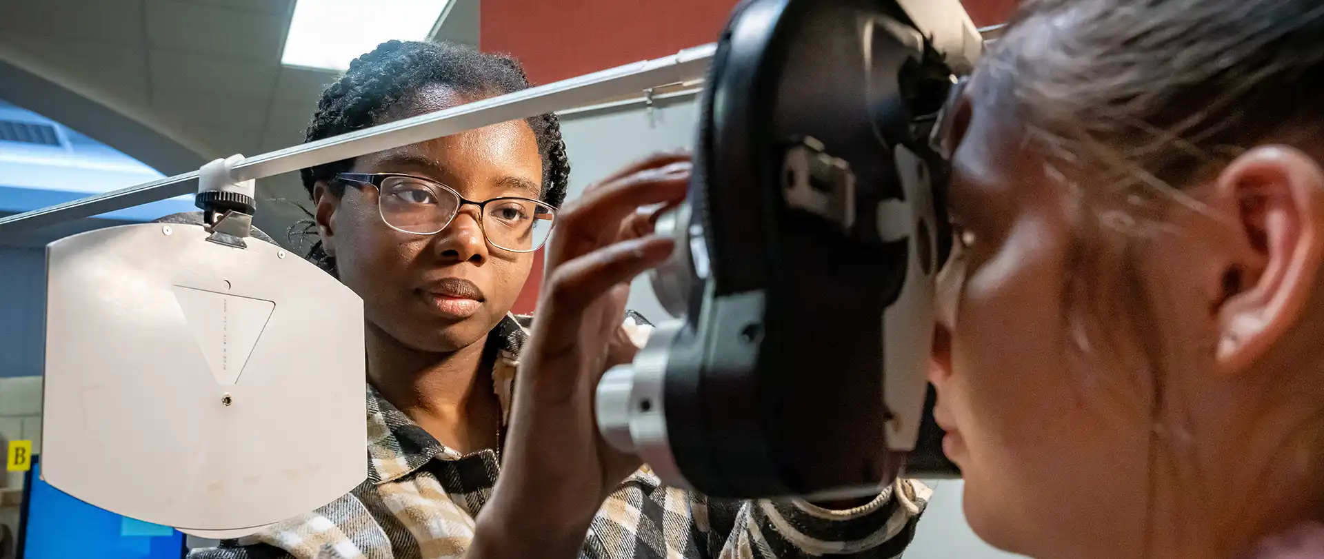 Student completing an eye exam