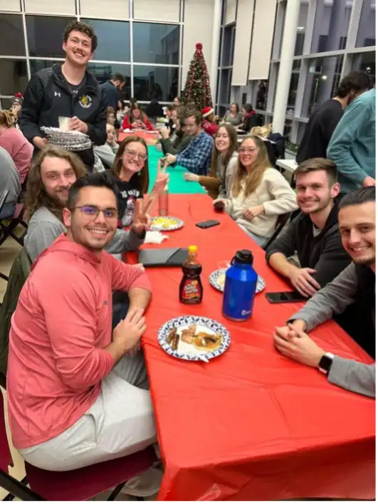 People around a red table