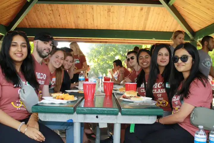 Group of students around a picnic table