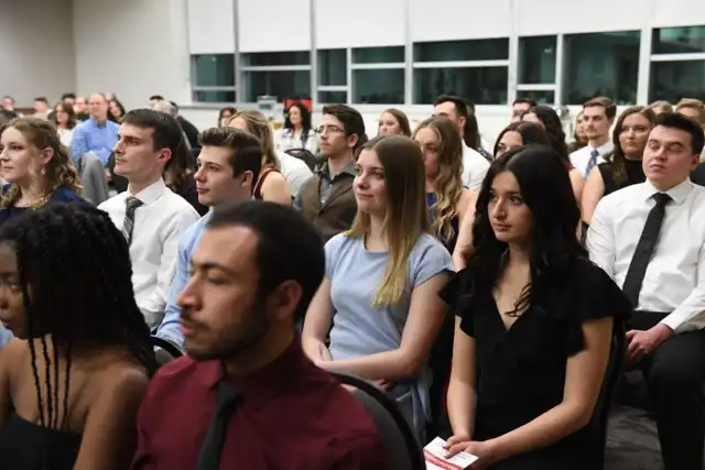 People sitting and watching the stage