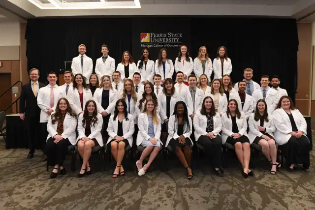 People in white coats posing for the camera