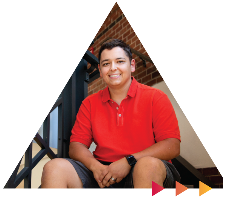 Student sitting on the stairs and smiling.