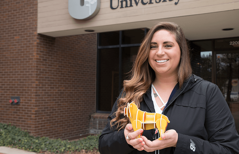 Amy Reed outside of the University Center with a little Bulldog. 