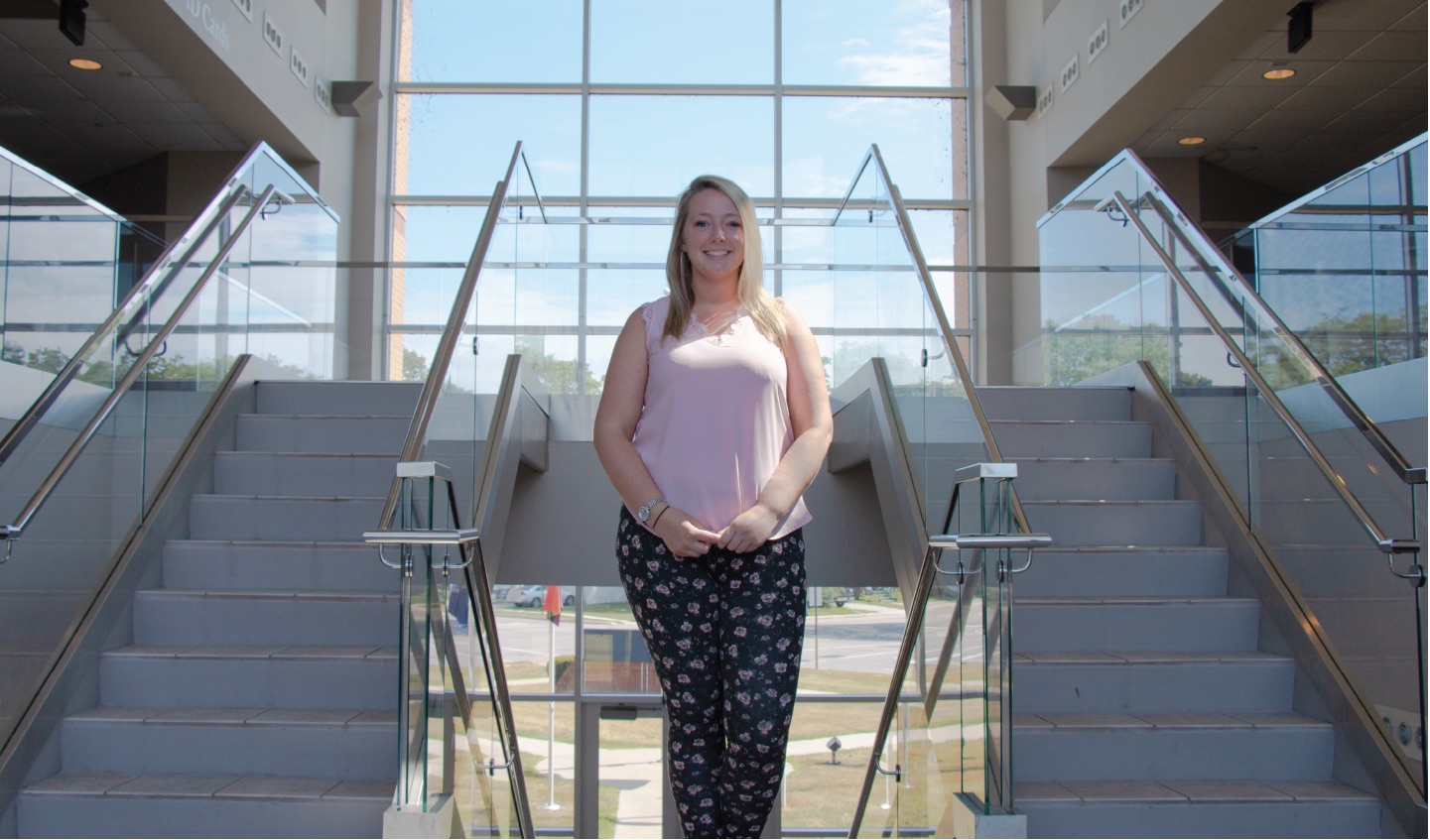 Student standing on the stairs.