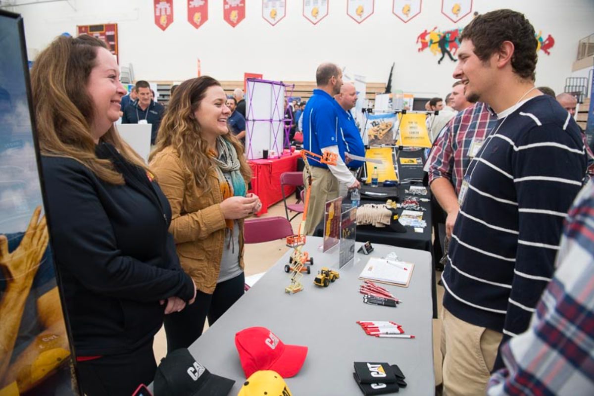 Student talking with employers at career fair