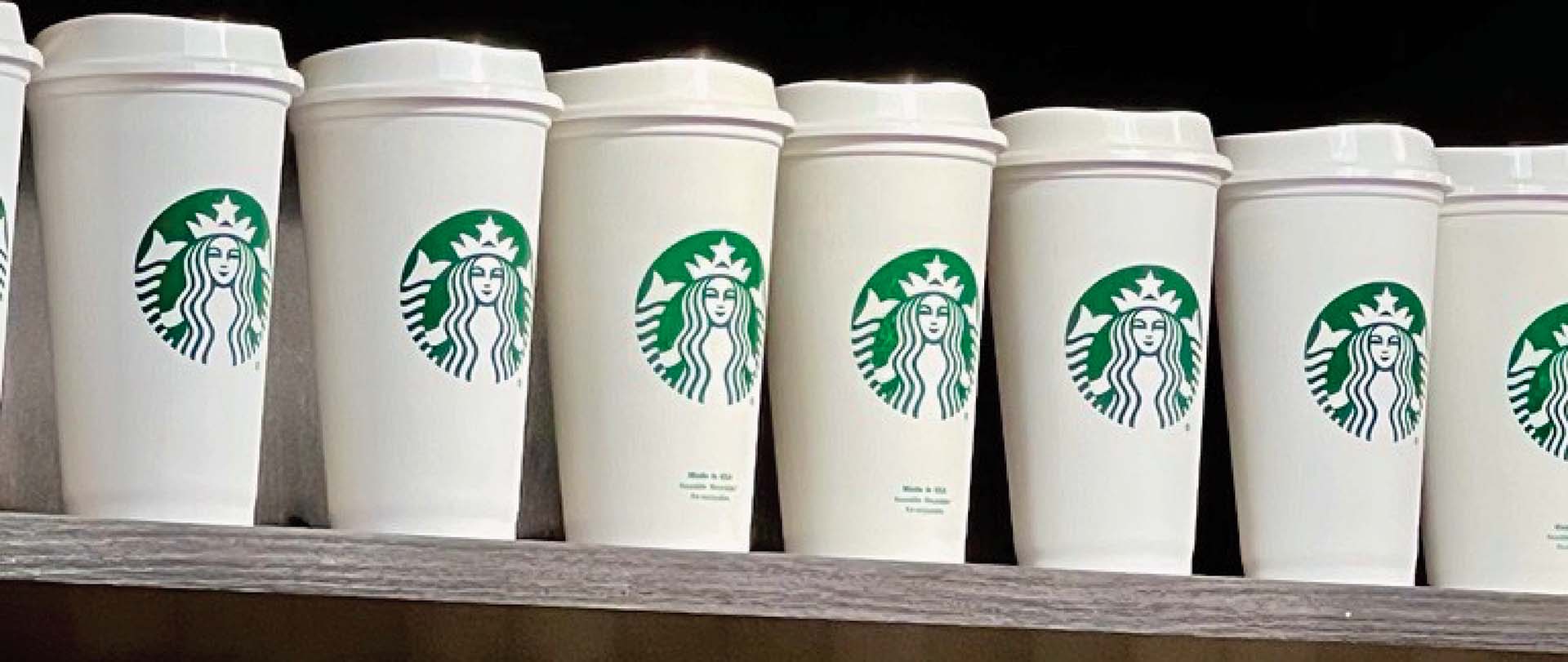 Starbucks cups on shelf