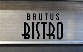 Counter of the "Brutus Bistro" restaurant with closed steel doors and the "Brutus Bistro" logo over the door.