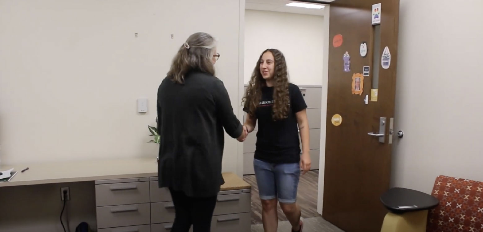 Dr. Meiser and student shaking hands