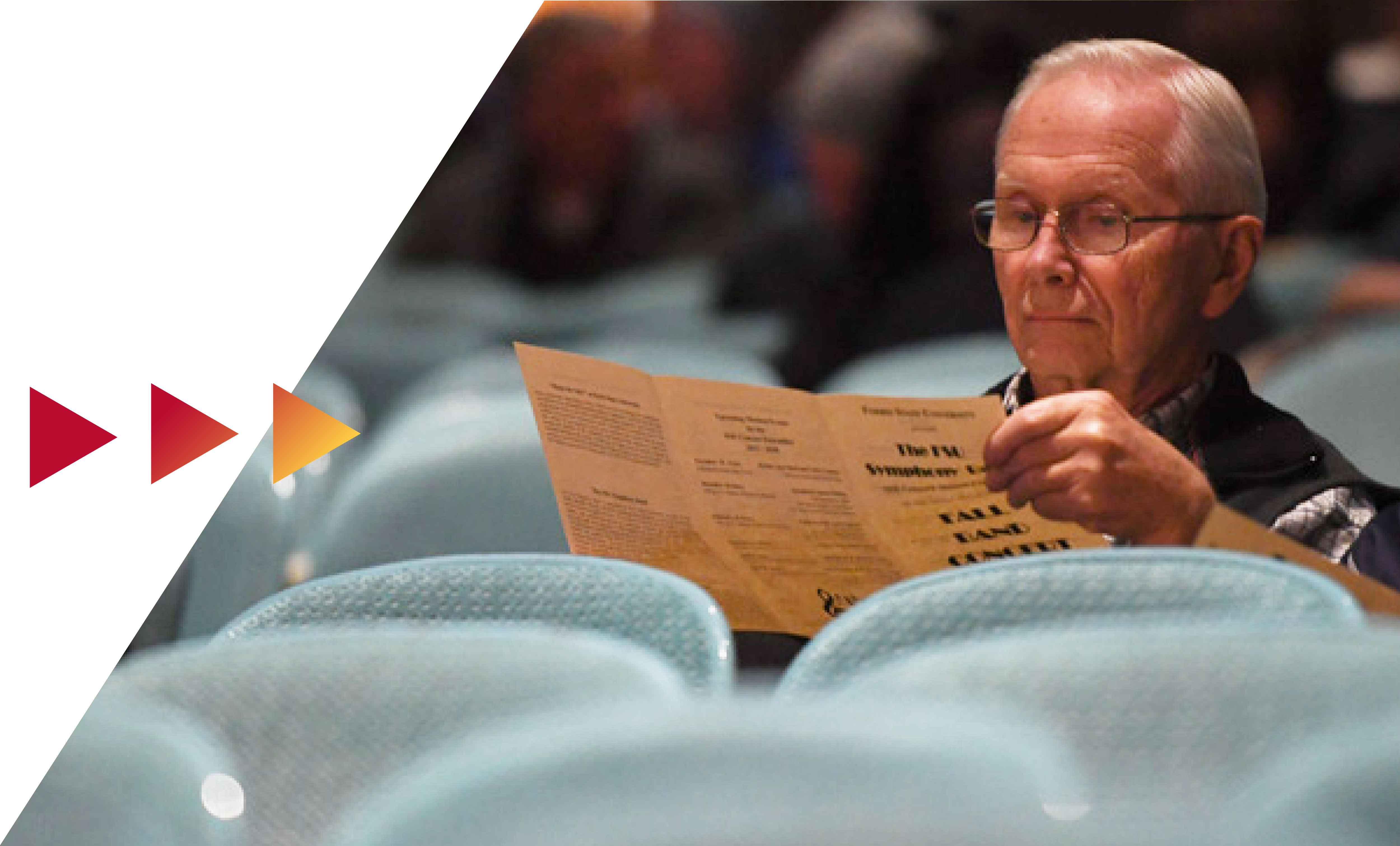 Audience member looking at playbill in Williams Auditorium